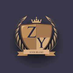 initial letter ZY logotype colored brown and gold isolated with shield, crown and laurel design, logo for college and sport club.