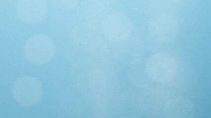 Blurred moving abstract white color light particles, blue background, lens flare