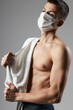© SHOTPRIME STUDIO - sporty man in medical mask towel on shoulders pumped up body