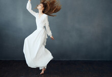 Woman In Long White Dress On Gray Background Dance Model Emotions
