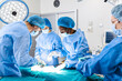 © Graphicroyalty - Surgical team performing surgery in modern operation theater,Team of doctors concentrating on a patient during a surgery,Team of doctors working together during a surgery in operating room,