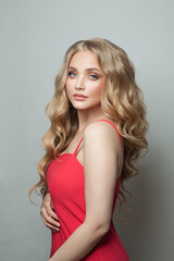 Wall Mural - pretty woman blonde fashion model in red dress on white background
