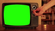 Man Hand Adjusting Dials Of An Old Television With Green Screen. Close Up. You Can Replace Green Screen With The Footage Or Picture You Want. You Can Do It With “Keying” Effect. 4K Resolution.