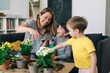 © cherryandbees - mother enjoy gardening houseplants at home with her children