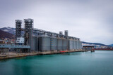 Fototapeta Panele - grain storage tanks in the port by the sea