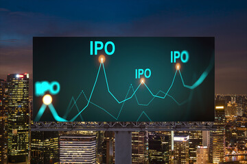 IPO icon hologram on road billboard over night panorama city view of Singapore. The hub of initial public offering in Southeast Asia. The concept of exceeding business opportunities.