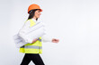 © deagreez - Profile photo of lady hold rolls paper walk look empty space wear helmet shirt vest isolated white color background