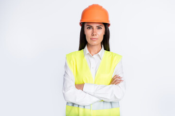 Wall Mural - Photo of self-assured worker lady crossed hands wear helmet shirt vest isolated white color background