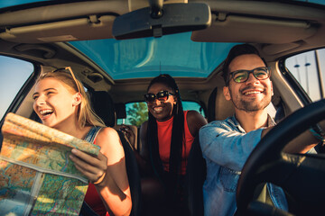 Wall Mural - Three best friends enjoying traveling at vacation in the car.