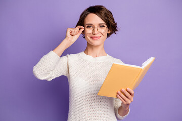 Sticker - Photo portrait of clever female student touching spectacles keeping book isolated on bright violet color background