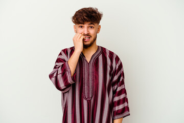 Wall Mural - Young Moroccan man isolated on white background biting fingernails, nervous and very anxious.