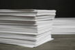 © New Africa - Stack of paper sheets on wooden table, closeup