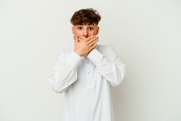 Wall Mural - Young Moroccan man wearing a typical arab clothes isolated on white background shocked covering mouth with hands.