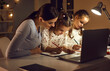 © Studio Romantic - Family busy with homework. Mother and kids doing school assignment together. Concentrated children developing good writing skills in student copybooks sitting at desk at home. Parent's help concept