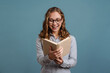 © Drobot Dean - Smiling attractive young woman reading a book