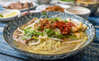 Malaysian soup noodles or locally know as Bihun Sup Utara with ingredients. Selective focus.