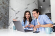 © F8  \ Suport Ukraine - Portrait of a young couple using laptop in the kitchen at home