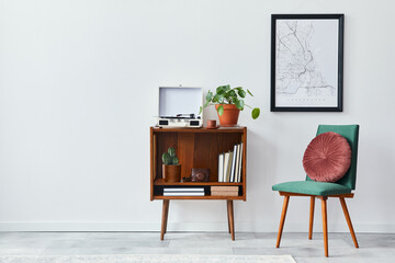 Retro composition of living room interior with mock up poster map, wooden shelf, book, armchair, plant, cacti, vinyl recorder, decoration and personal accessories in stylish home decor.