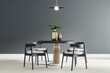 Black round table with wooden chairs around in the center of modern dining room with black wall and light ceramic tiles floor