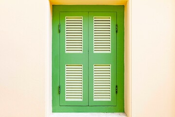 Vintage green wooden door and white yellow cement wall