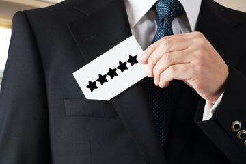 Businessman takes out a business card from his pocket with the five star rating icon.