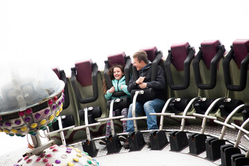 Boy and girl enjoying amusement park ride, Piotrkow Trybunalski, Lodzkie, Poland