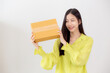 Asian woman smiling and holding cardboard box with surprise at home, happy female carrying parcel box with excited, present and gift, packaging for deliver, online shopping store and service concept.
