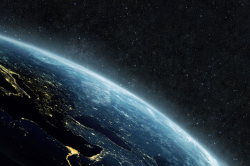 Wall Mural - beautiful blue planet earth with yellow city lights on the starry background in outer space