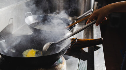 Canvas Print - Chef stir fry busy cooking in kitchen