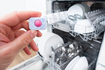 A tablet of a detergent for washing dishes in dishwashing machine