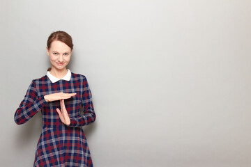 Portrait of happy girl showing timeout gesture with hands and smiling