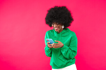 Cheerful black woman with a cell phone.