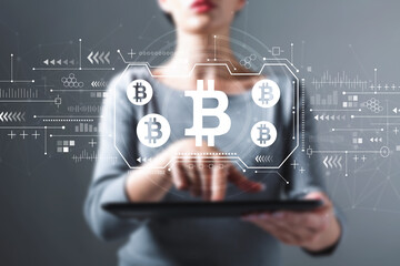 Canvas Print - Bitcoin theme with business woman using a tablet computer