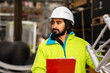 © Cavan - Worker young man with helmet and beard working in a warehouse