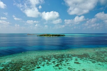 Wall Mural - Bird's eye view of tropical islands in the ocean. View of the islands from a drone. Maldives, Thinadhoo (Vaavu Atoll), Dhigurah