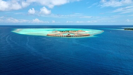 Wall Mural - A bird's eye view of a luxury ocean resort in the Maldives. The concept of a luxury vacation, a honeymoon on a tropical island