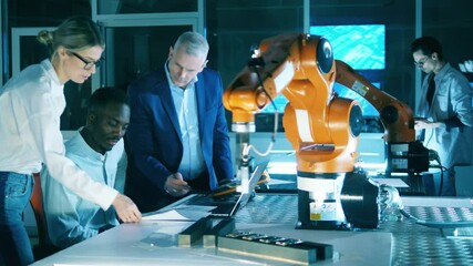 Wall Mural - group of researchers are experimenting with a robotic mechanism. professional engineers working with