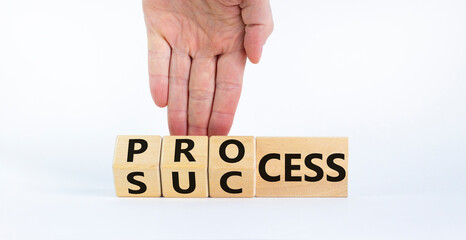 Wall Mural - Success process symbol. Businessman turns wooden cubes and changes the word 'success' to 'process'. Beautiful white background, copy space. Business, success process concept.