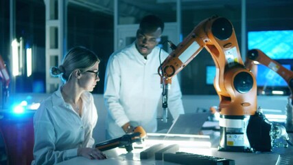 Wall Mural - two researchers are studying a robotic mechanism