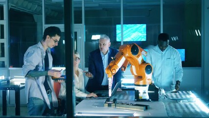 Wall Mural - scientists are operating a robotic mechanism. professional engineers working with innovative equipme