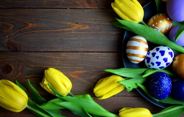 Wall Mural - Easter card: yellow tulips and Easter eggs