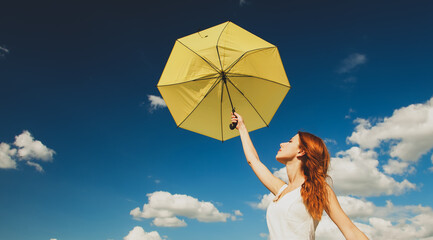 Wall Mural - Redhead girl with umbrella at field