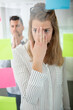 © auremar - woman overwhelmed by numerous sticky notes on window