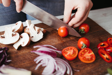 Woman preparing healthy food in her kitchen. Clean healthy detox eating. Vegan, vegetarian concept, conscious lifestyle