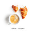 Coffee cup and fresh croissant layout