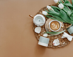 Canvas Print - Coffee cup and bouquet of white tulips . Concept of holiday, birthday, Women Day. Romantic Feminine flat lay. Good morning. still life.