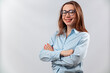 © Yura - beautiful girl in glasses and a blue shirt on a white background looks into the frame. isolated