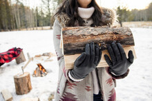 Woman Carrying Firewood In Snow