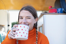Portrait Happy Young Woman Drinking Tea In Camper Van