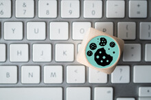 Dice With Cookie Icons On A Laptop Keyboard Conceptual Of The GDPR Regulations Introduced By The EU Governing Data Collection And Privacy Of Information For Individuals Online.